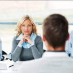 image of  man and woman sitting across from each other at a table